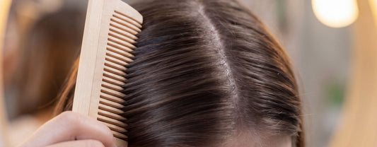 Close-up of woman combing her hair